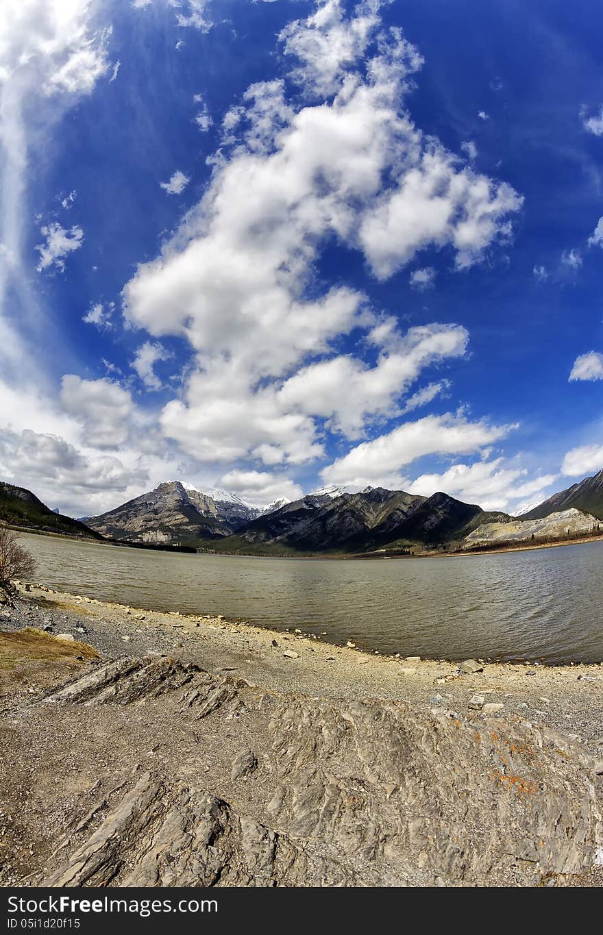 Lac des Arcs with part of the Canadian rocky mountains in the background thru a fisheye lens. Lac des Arcs with part of the Canadian rocky mountains in the background thru a fisheye lens