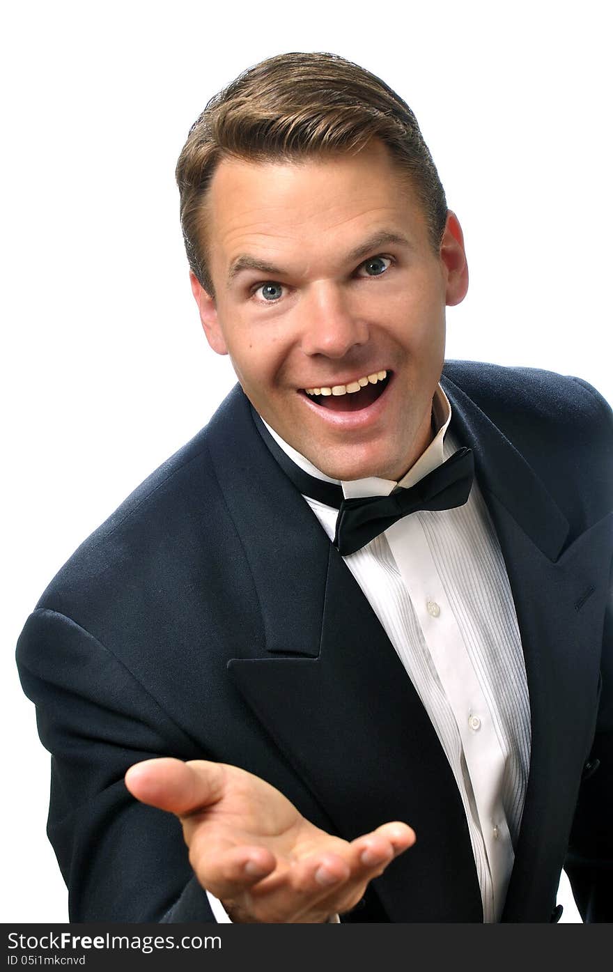 Portrait of handsome male Caucasian host wearing black tuxedo making welcoming hand gesture on white background. Portrait of handsome male Caucasian host wearing black tuxedo making welcoming hand gesture on white background