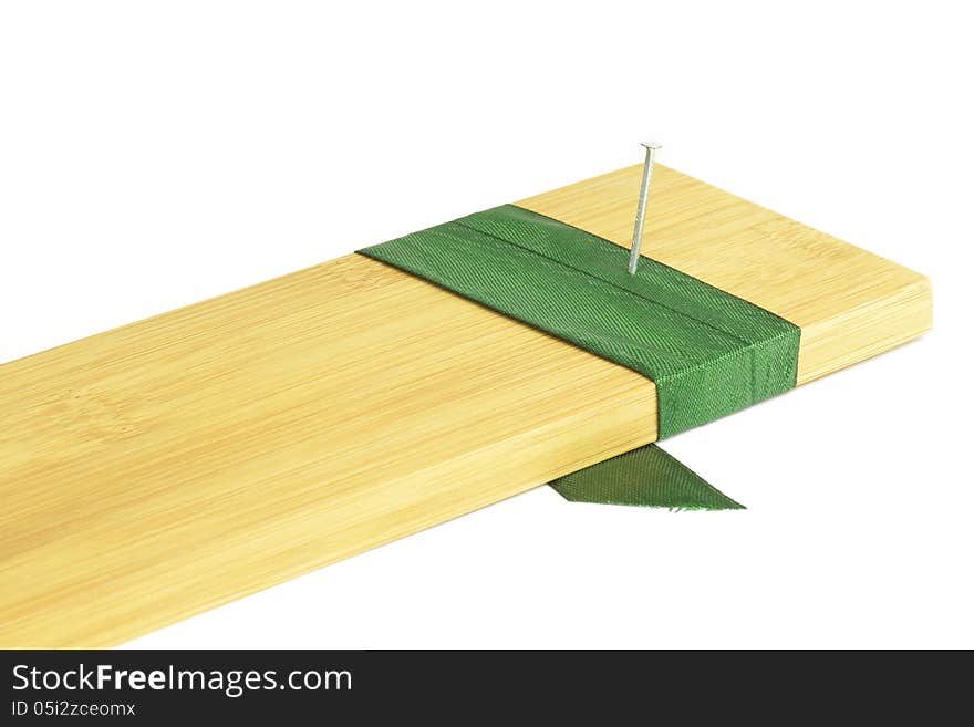 Nail into a board with green ribbon. Nail into a board with green ribbon.