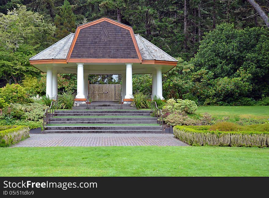 Large white gazebo in green park