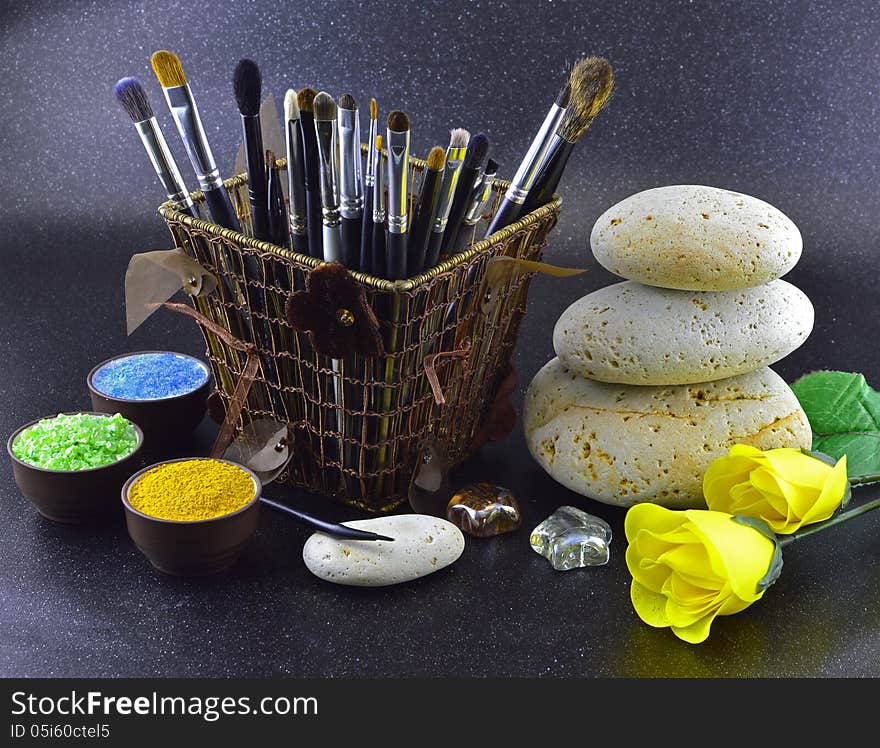 Composition of brushes with yellow roses on black background. Composition of brushes with yellow roses on black background