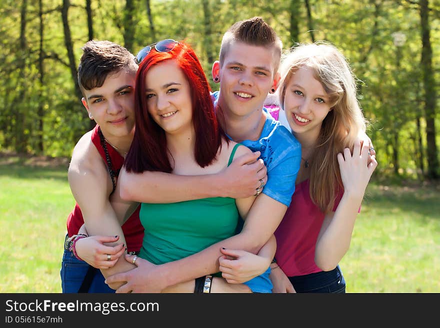 Young teenage group with colored shirts are having fun. Young teenage group with colored shirts are having fun