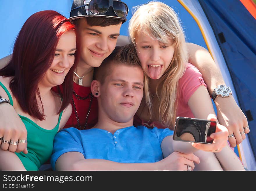 Group is taking a photo while girl sticks her tongue out