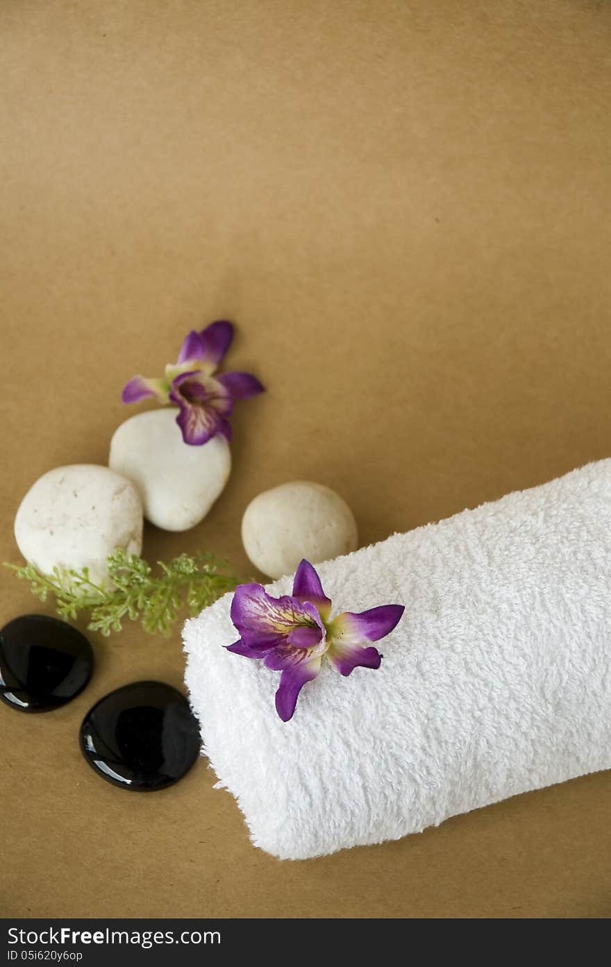 Orchid on white towel spa with brown background. Orchid on white towel spa with brown background