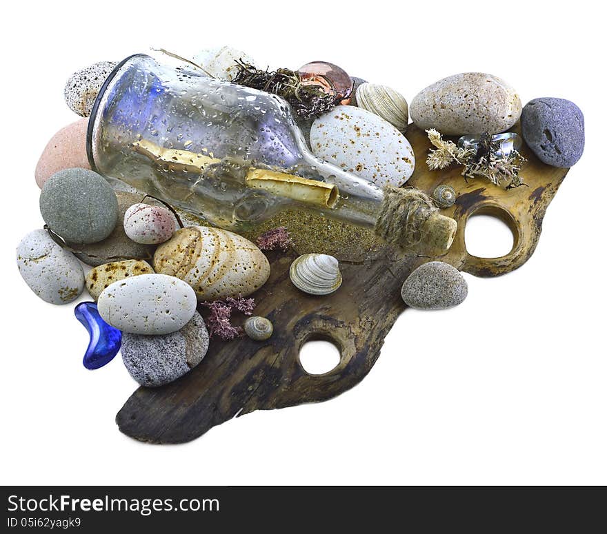 Glass bottle with letter inside on stones and shells isolated. Glass bottle with letter inside on stones and shells isolated