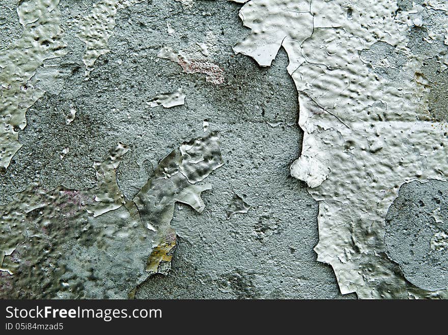 Grunge graffiti texture with closeup detail of old discoloured weathered paint peeling off a cement wall