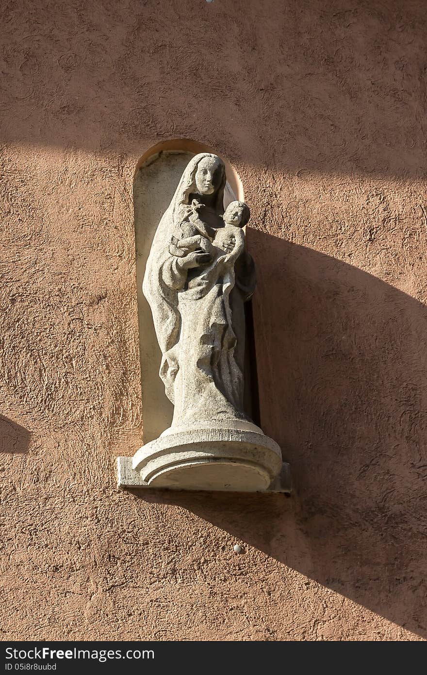 Madonna with Child, sculpture on a wall in Wurzburg, Germany.