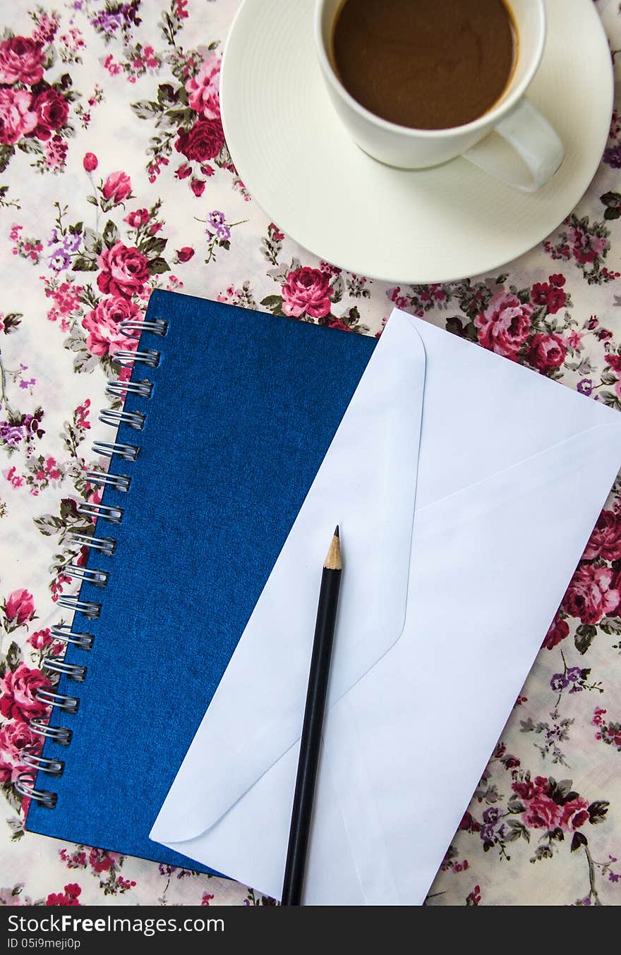 Blank envelopes on the table with pencil and coffee cup and blue