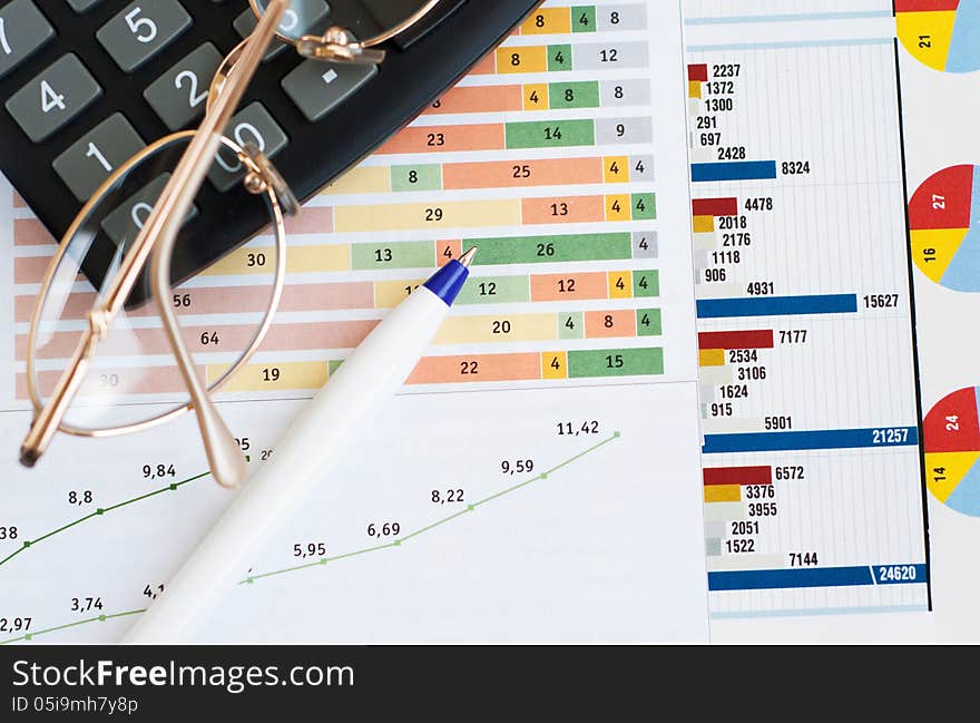 Chart with calculator, glass and pen. Chart with calculator, glass and pen