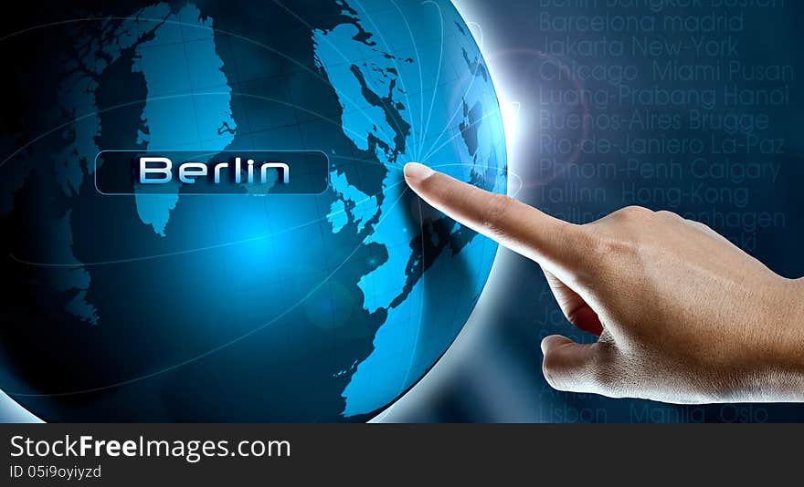 A woman finger point Berlin city on the world map. A woman finger point Berlin city on the world map