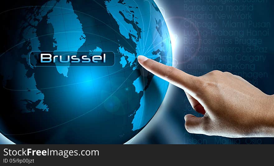 A woman finger point Brussel city on the world map. A woman finger point Brussel city on the world map