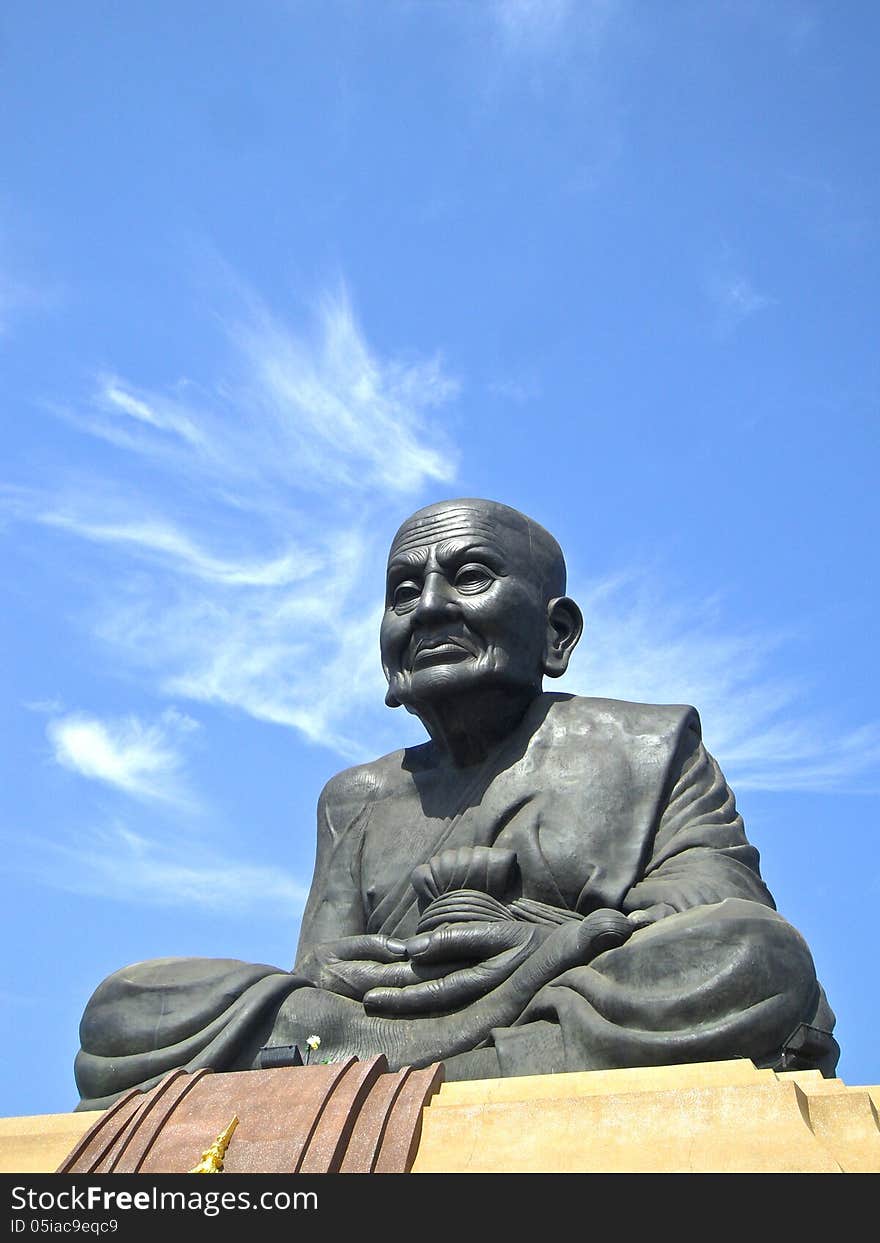 The Statue in temple on background sky. The Statue in temple on background sky