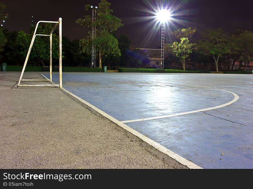 Goal on stone soccer field night view