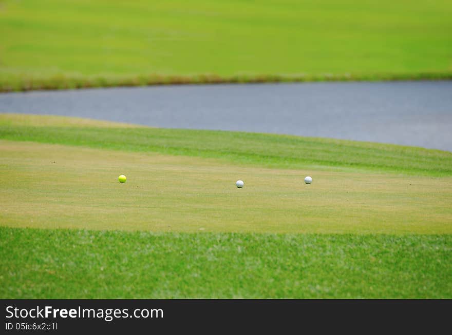 Three golf balls on the green