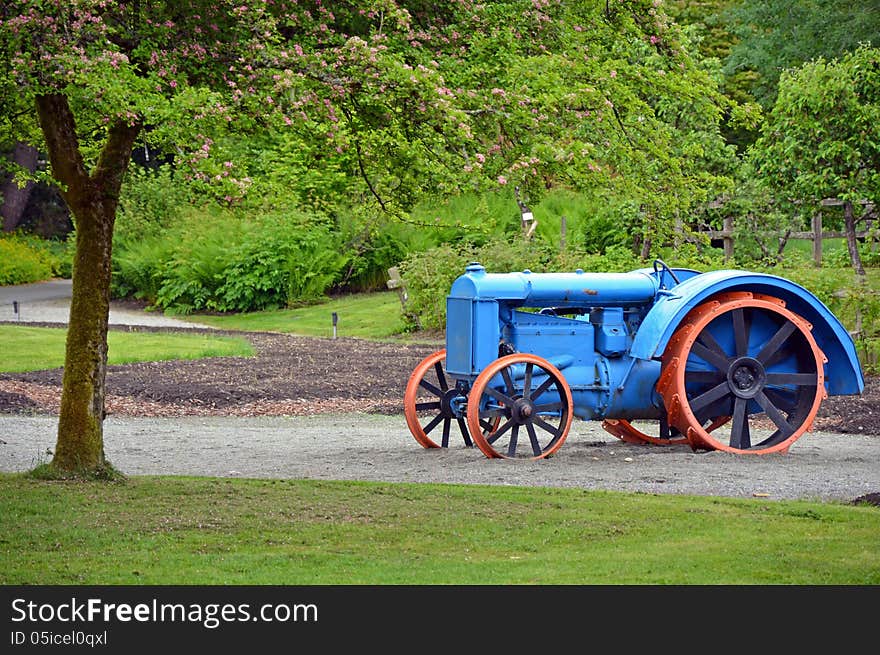 Old blue and orange tractor on display on farm