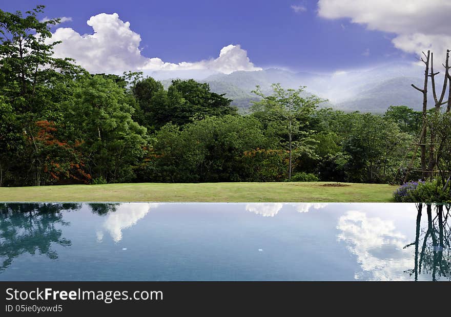 Cloud Reflections On The Infinity Pool With Beautiful Landscape