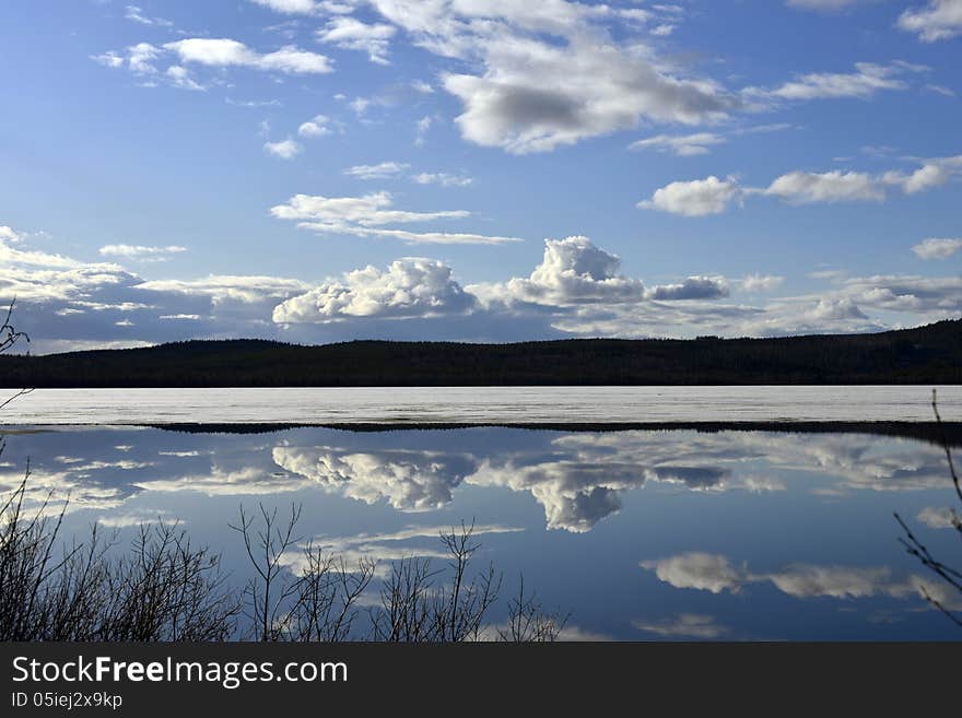 Mirror blank lake against beautiful sky. Mirror blank lake against beautiful sky