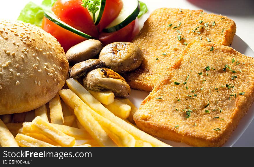 Portion for breakfast, meat, fries and bun. Portion for breakfast, meat, fries and bun.