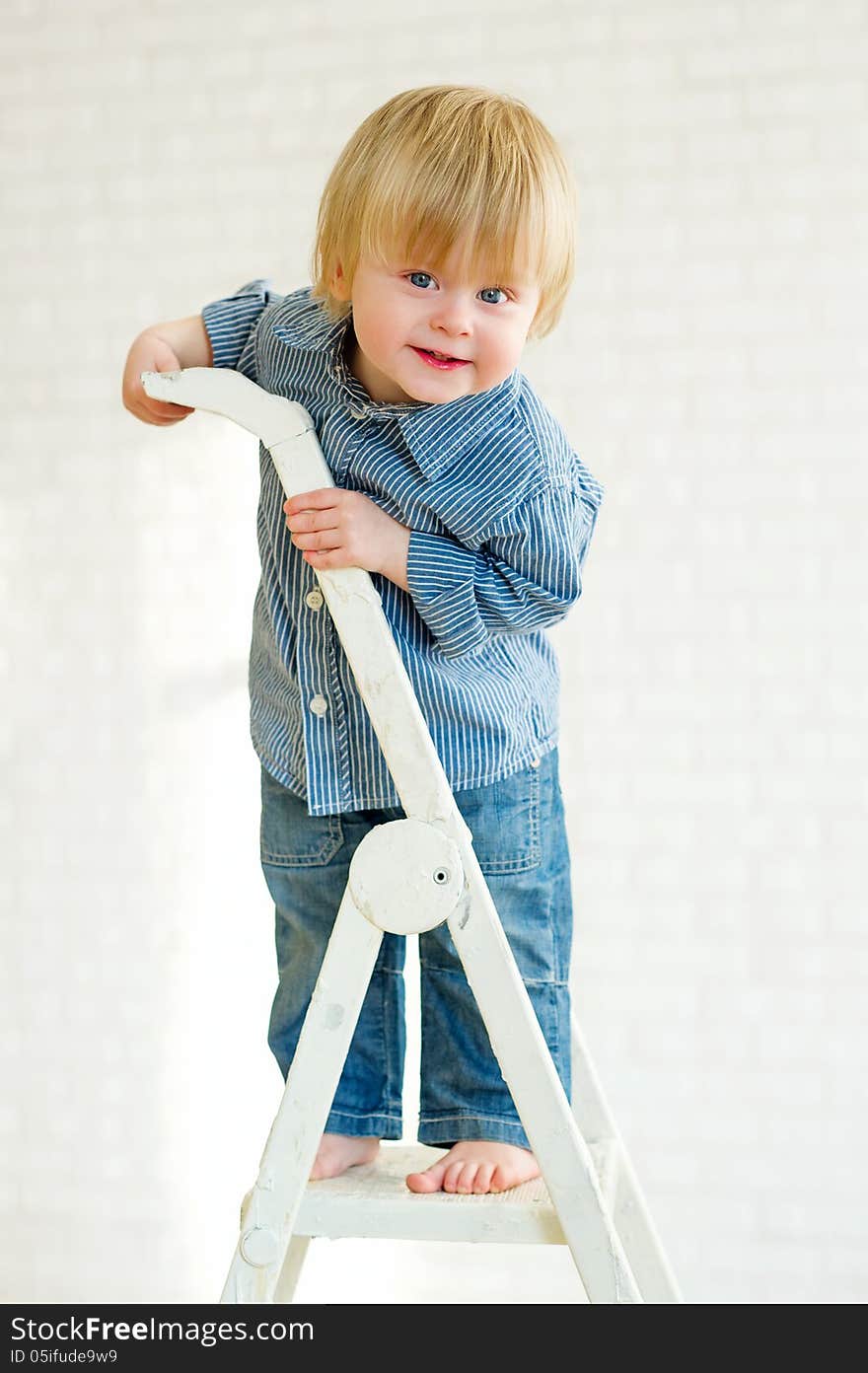 Cute little boy learning to climb the ladder. Cute little boy learning to climb the ladder