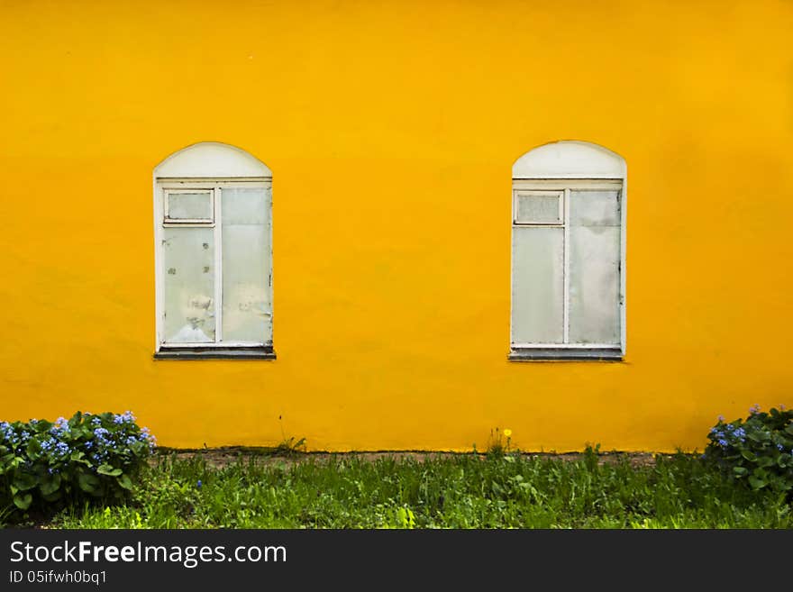 Iron Windows in the orange wall of the house