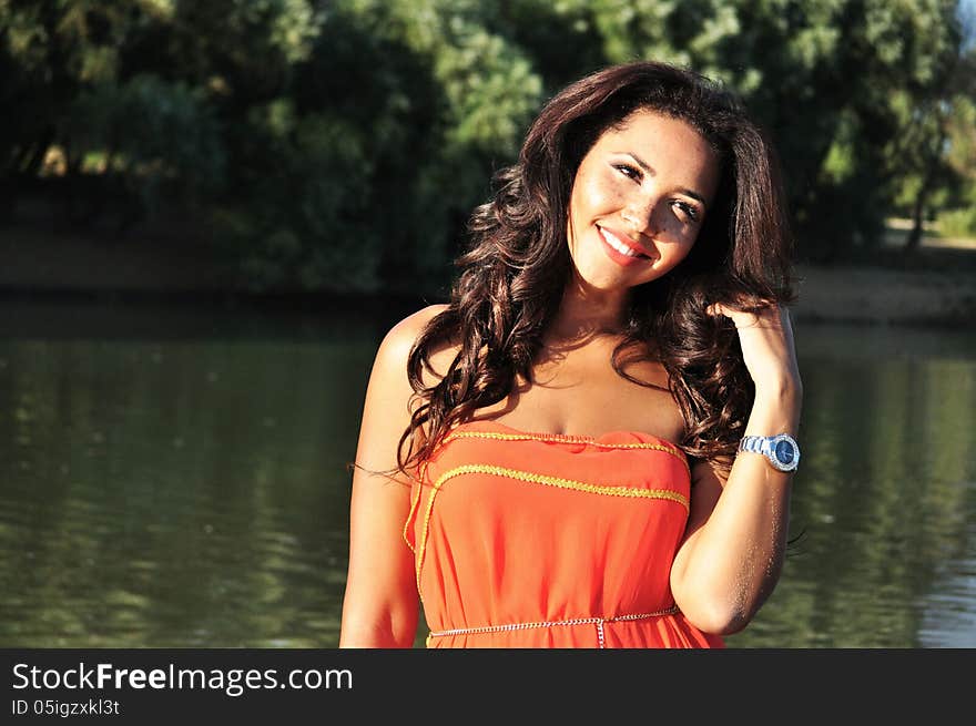 Outdoor portrait of an attractive young woman with long black hair . Outdoor portrait of an attractive young woman with long black hair .