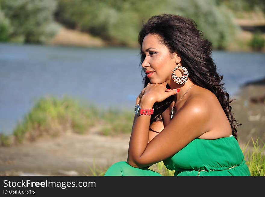 Outdoor portrait of an attractive young woman with long black hair . Outdoor portrait of an attractive young woman with long black hair .