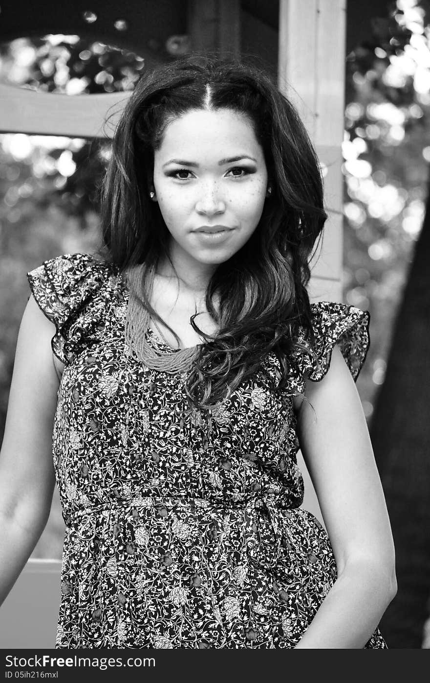 Black and white portrait of an attractive young woman with long black hair . Black and white portrait of an attractive young woman with long black hair .