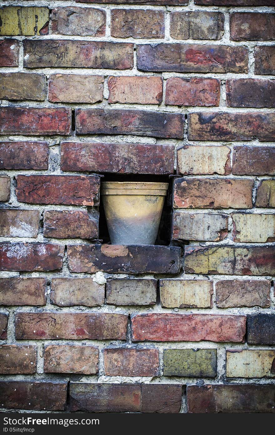 Old brick wall pattern closeup with flowerpot.