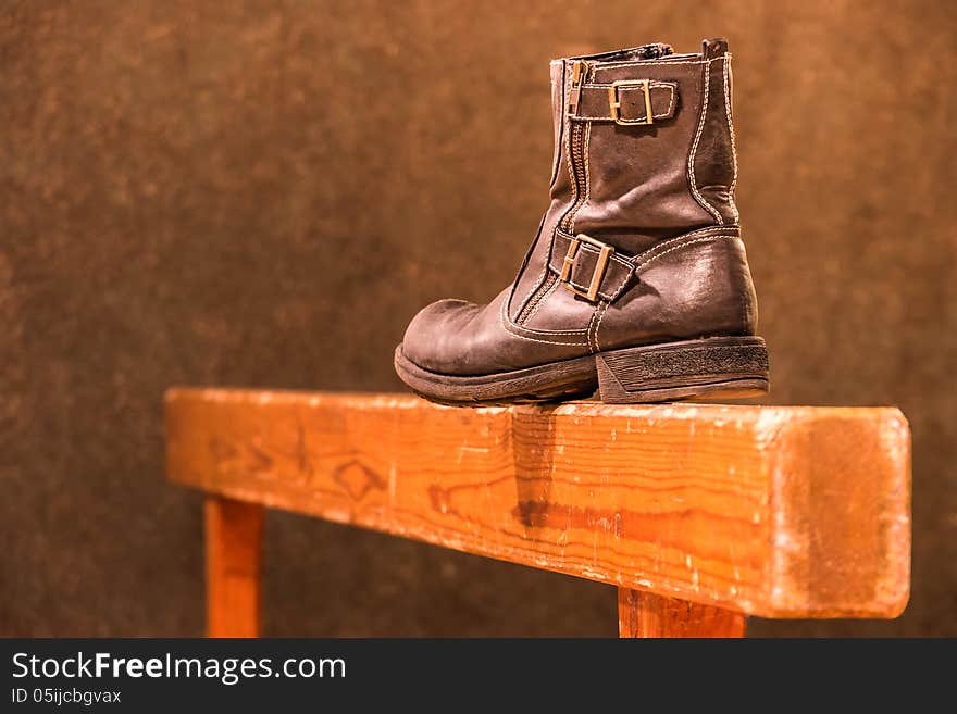 Perspective view of a vintage gymnastic beam with an old fashioned used boot. Perspective view of a vintage gymnastic beam with an old fashioned used boot.