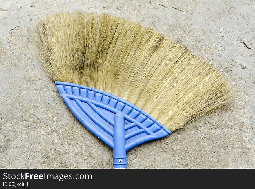 Used Broom with concrete floor