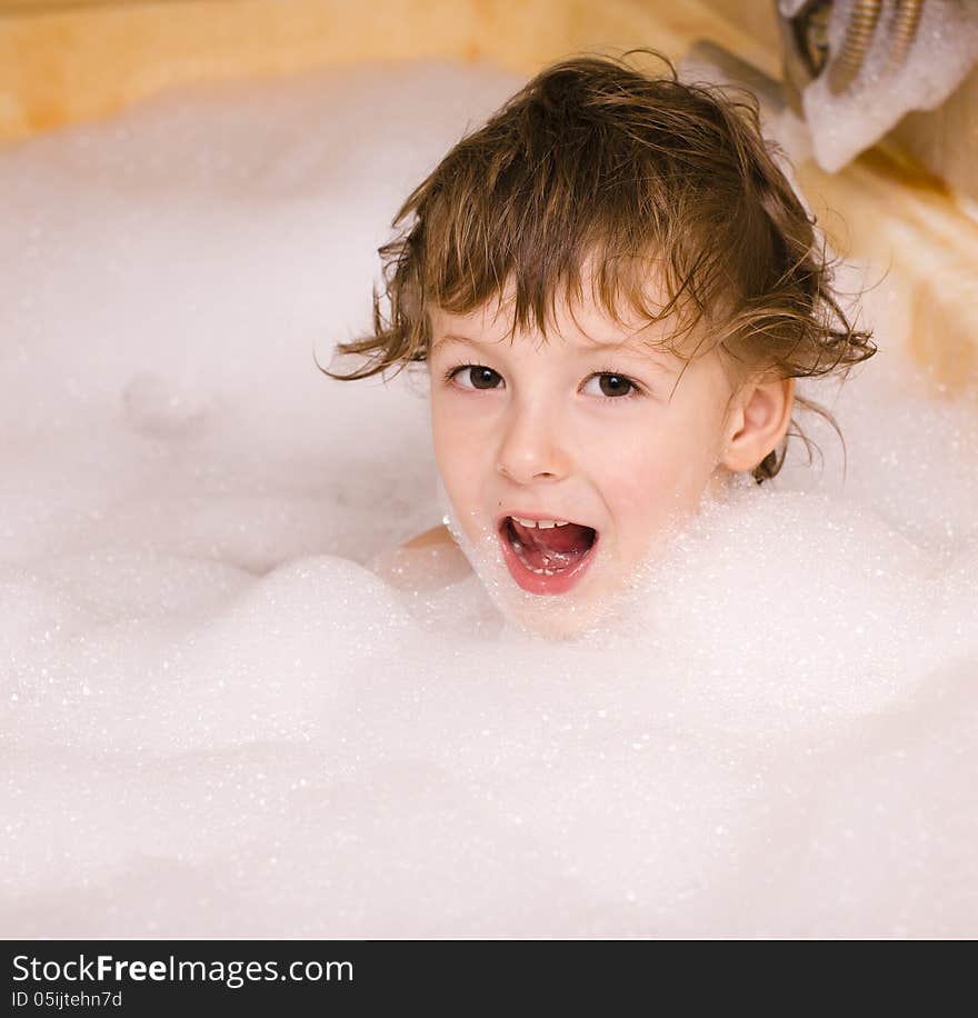 Cute little boy in bathroom with foam close up