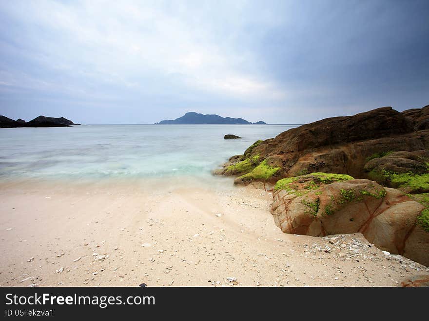 Many rocks on the beach under cloudy sky. Many rocks on the beach under cloudy sky