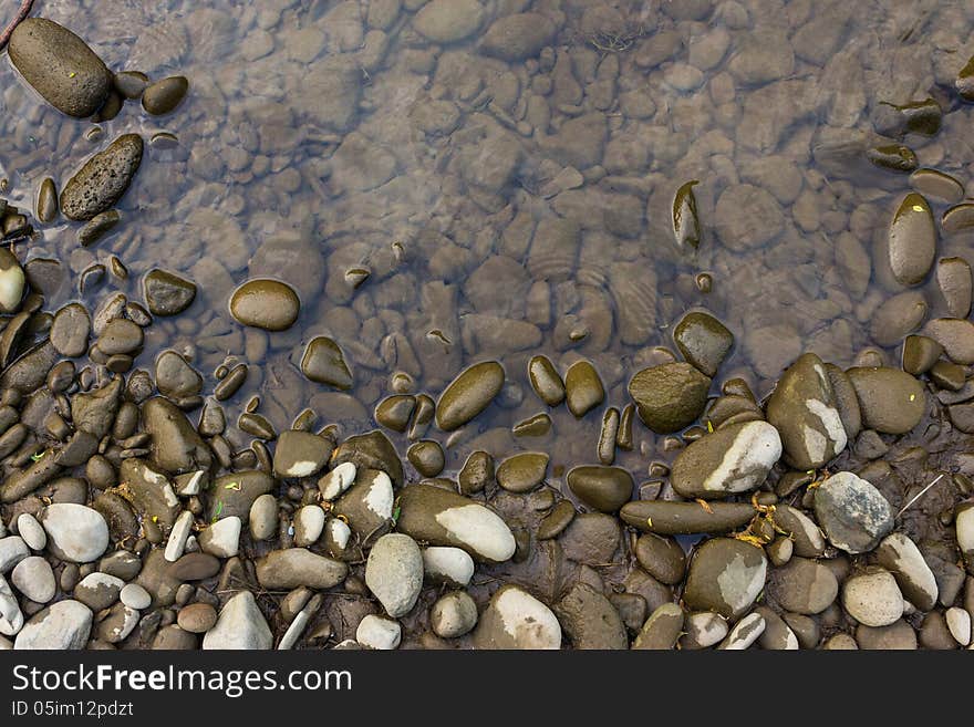 Wide shore with gray river stones and water. Wide shore with gray river stones and water