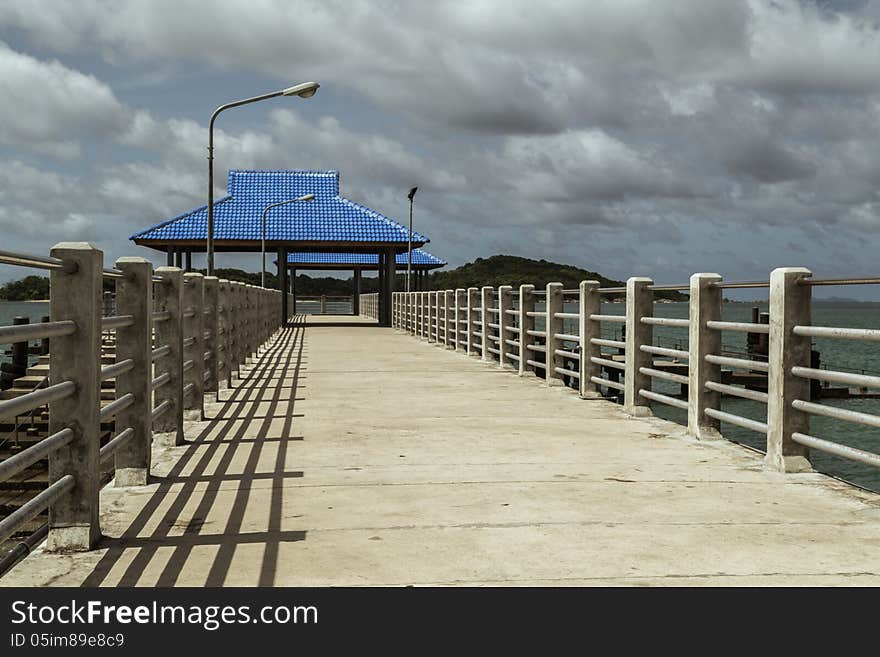 A long bridge above the sea leading to a seaport. A long bridge above the sea leading to a seaport