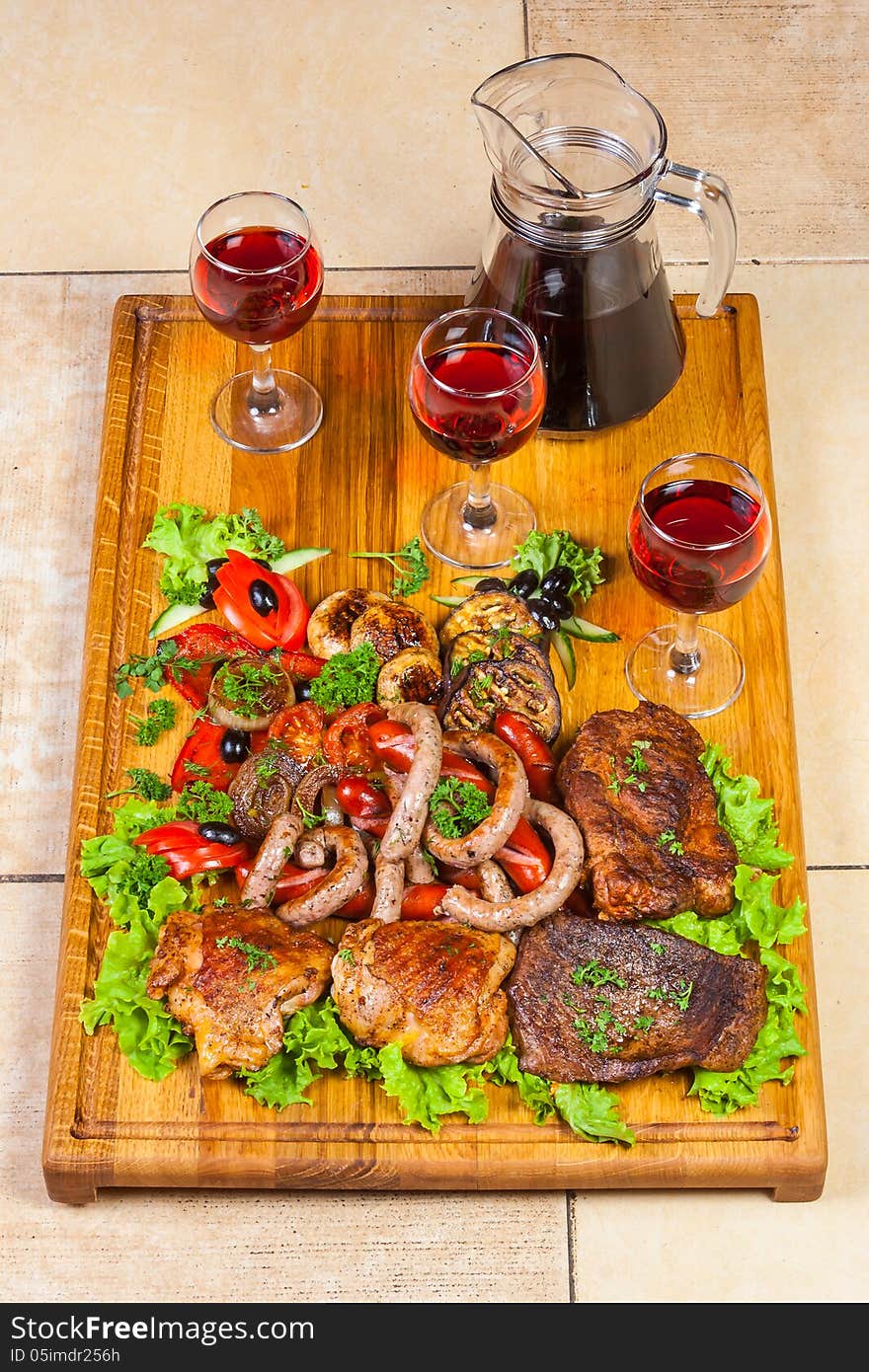 Grilled meat, sausages  and  herbs with wine