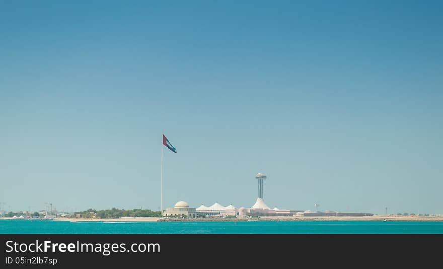 The United Arab Emirates flag, flying next to the Abu Dhabi Heritage Theatre.