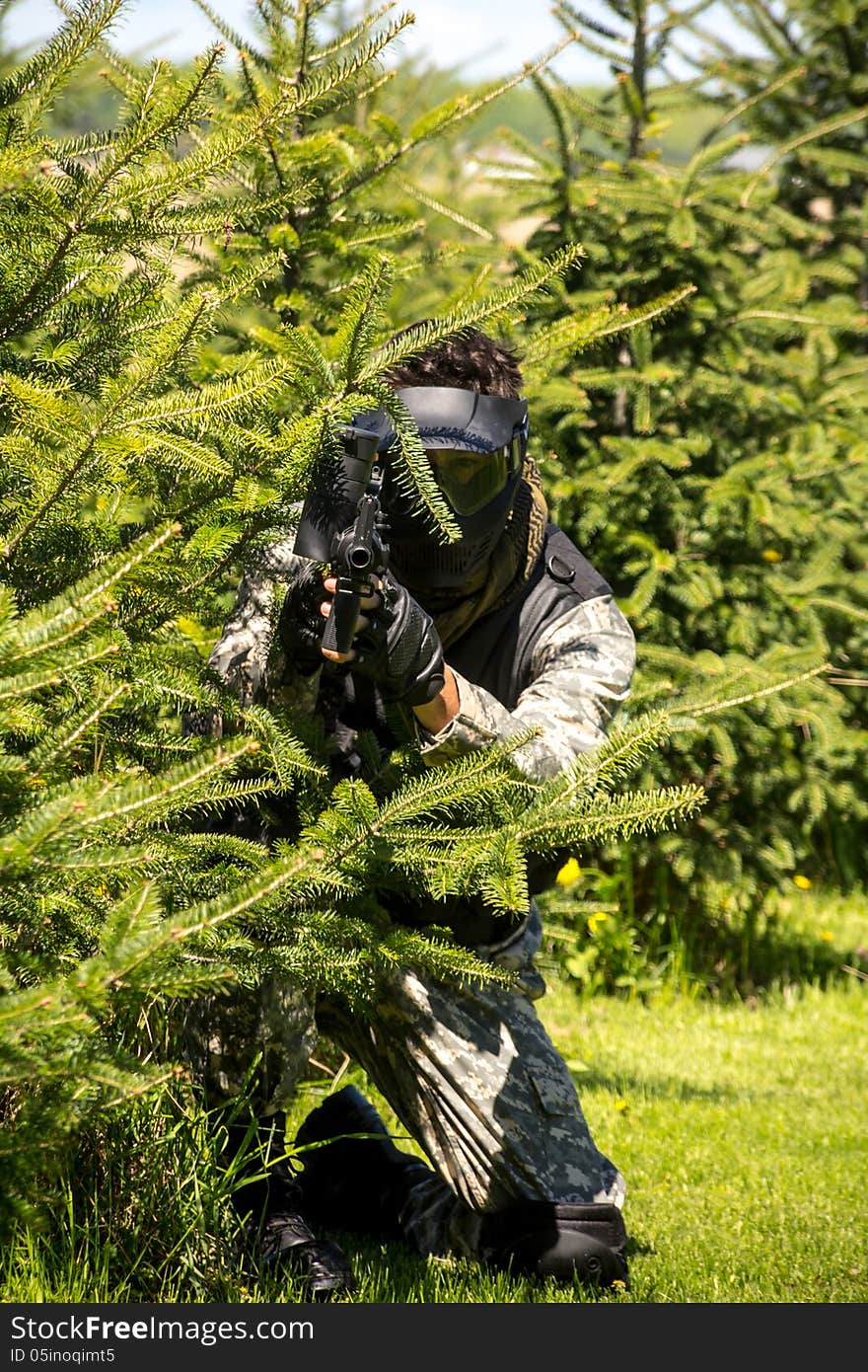 Men aiming playing paintball game outdoor. Men aiming playing paintball game outdoor