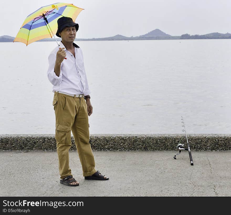 Senior fisherman catches a fish in the sea