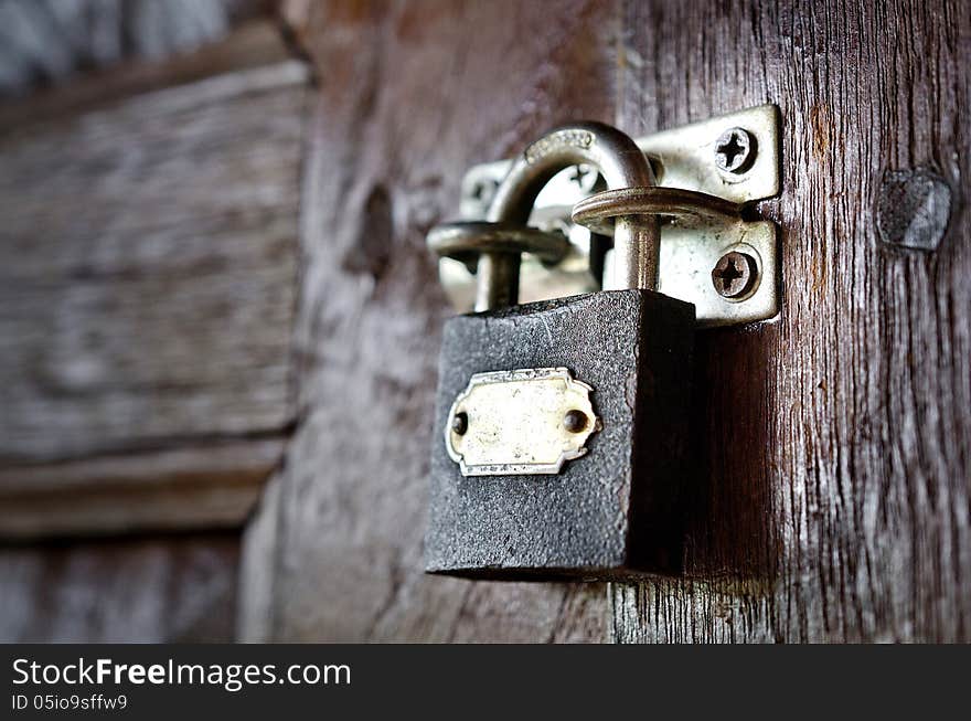 Old rusty vintage lock on a wooden door. Old rusty vintage lock on a wooden door.