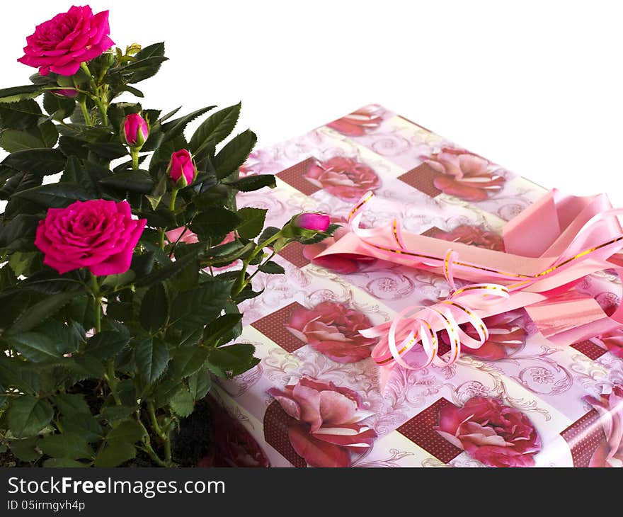 Box with a gift and bouquet of roses on a white background