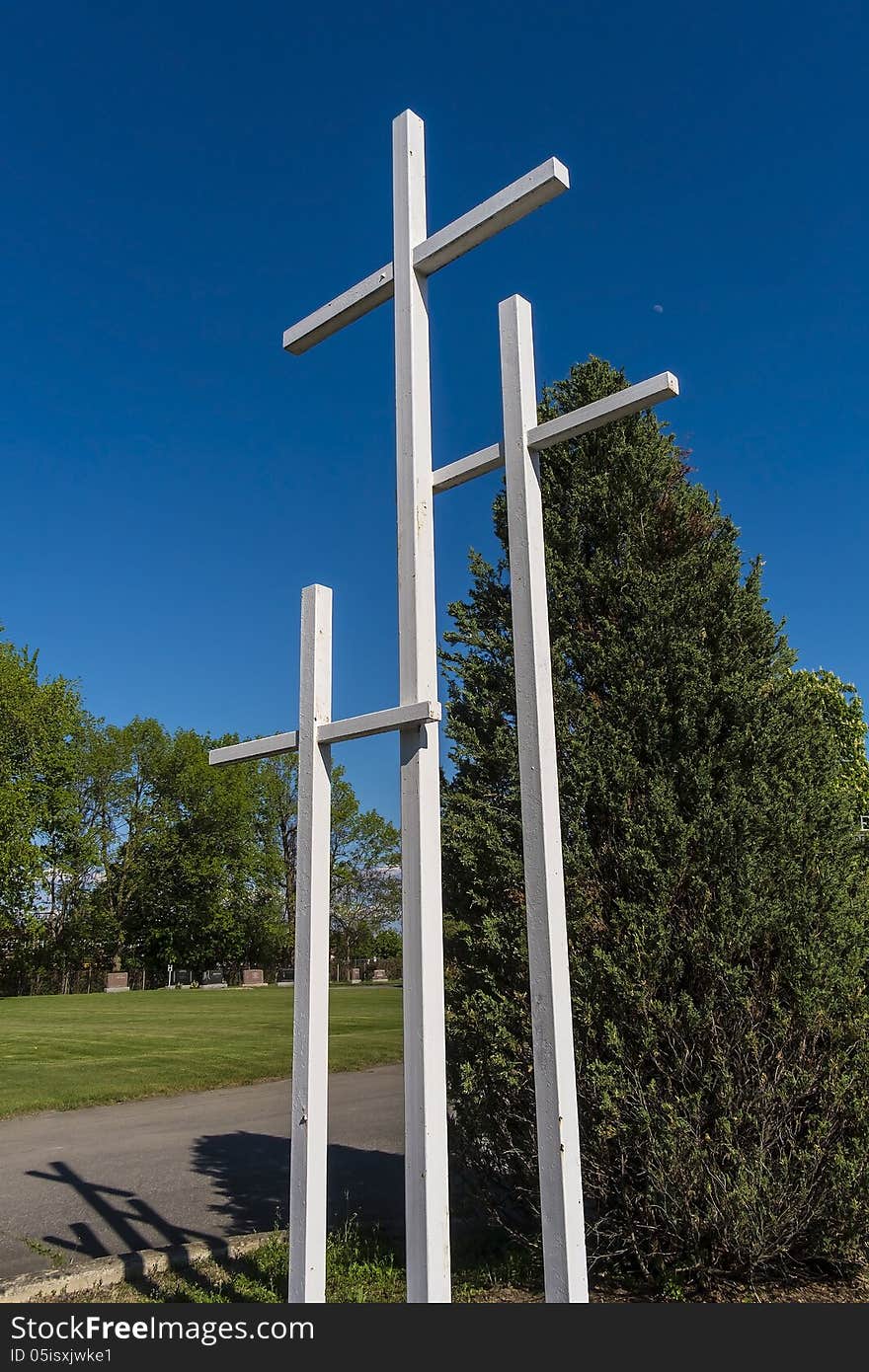 3 crosses in front of a cimetary