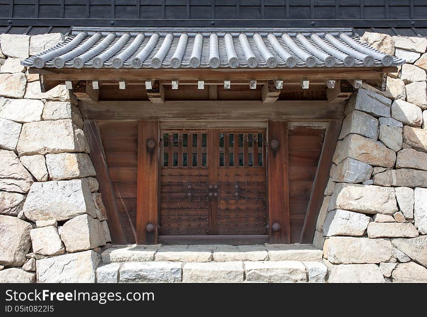 Closed japanese castle gate and rock wall