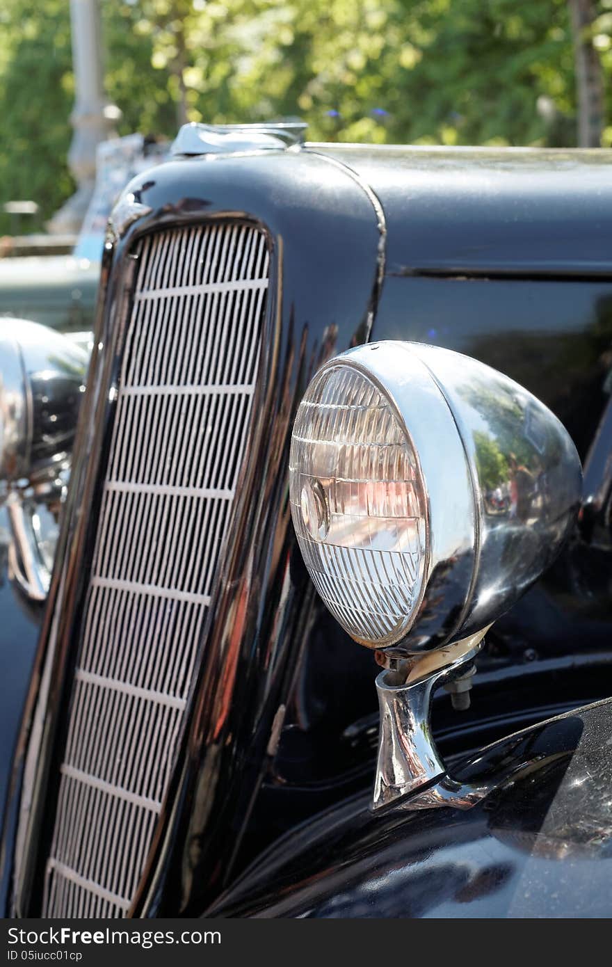 Retro car headlight, radiator close-up day. Retro car headlight, radiator close-up day