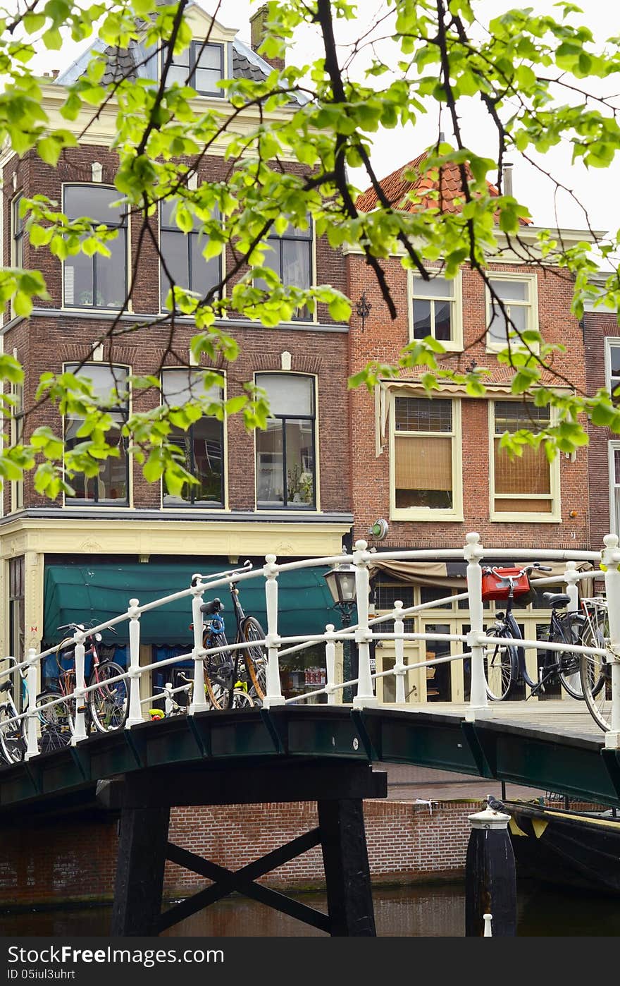 A Typical Scene From The Netherlands Of Bikes On A Brodge Over A Canal. A Typical Scene From The Netherlands Of Bikes On A Brodge Over A Canal