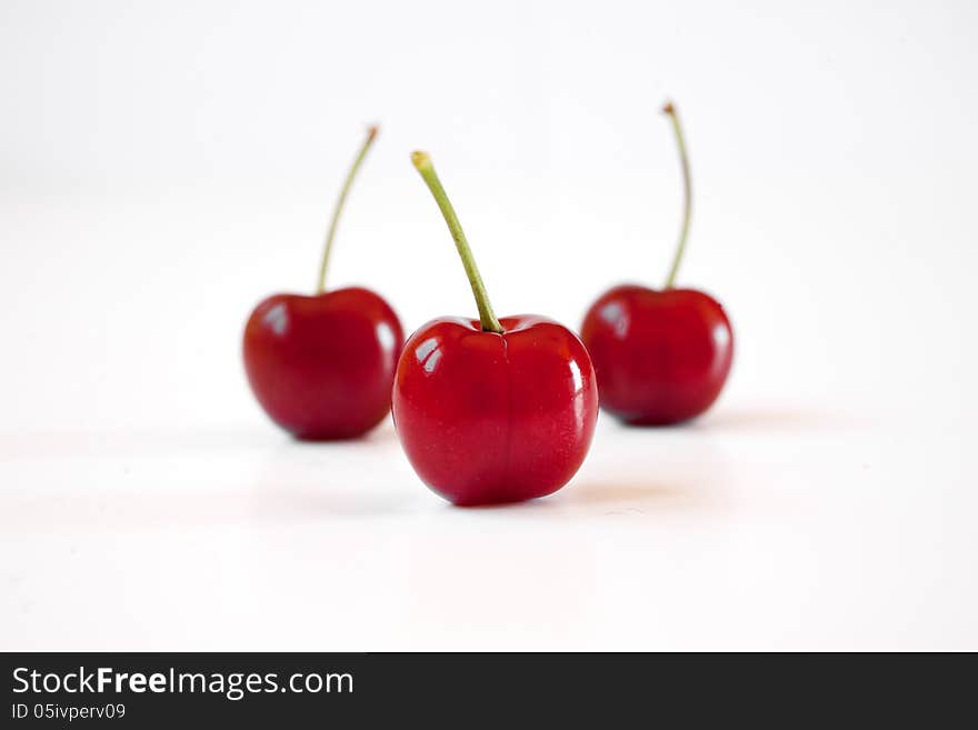 Close up of three cherries on white background. Close up of three cherries on white background