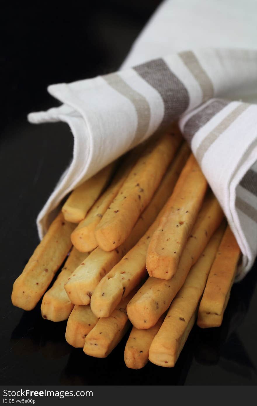 Bacon breadstick wrapped in a napkin. Bacon breadstick wrapped in a napkin.