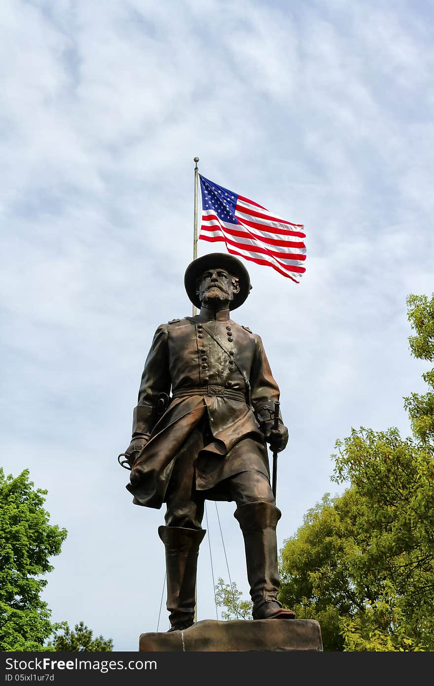 Statue of General William Wells with the American flag in the background