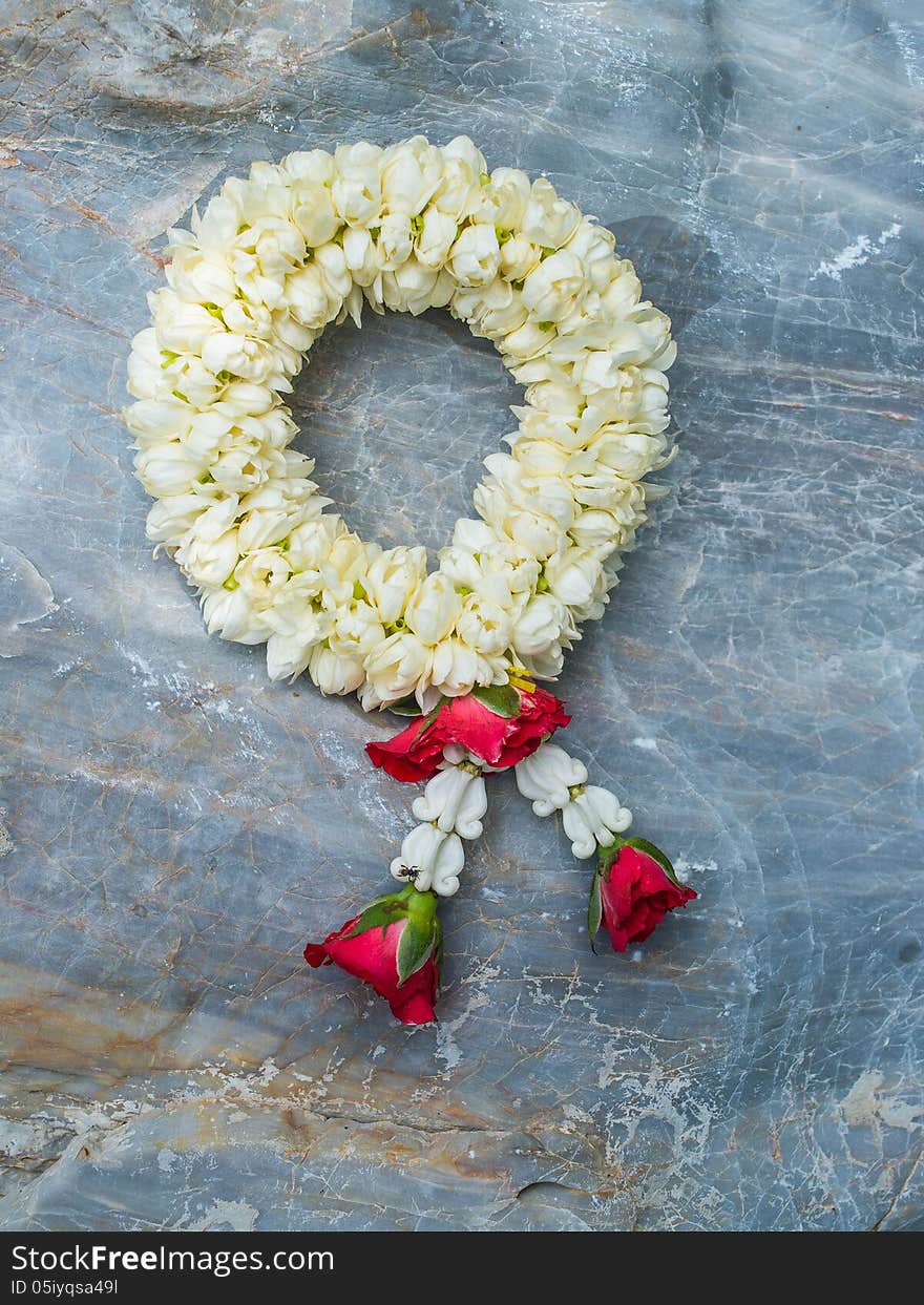 A soft garland on surface of a hard rock.