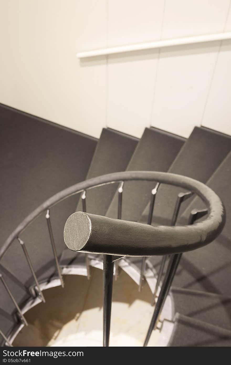 Staircase in modern building interior: handrail first. Staircase in modern building interior: handrail first