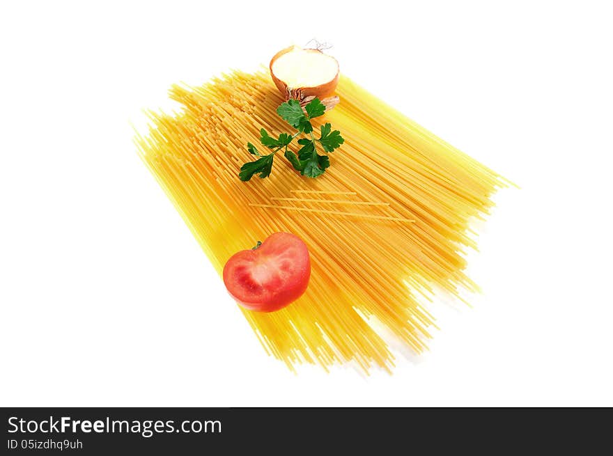 Raw spaghetti decorated with onion, tomato and parsley isolated on white